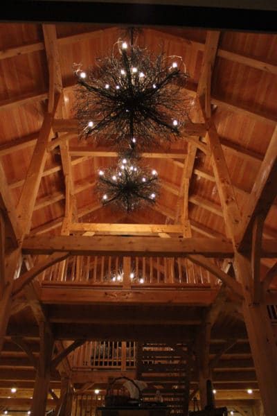 Foyer with Vaulted Ceiling Lit by Rustic Chandeliers